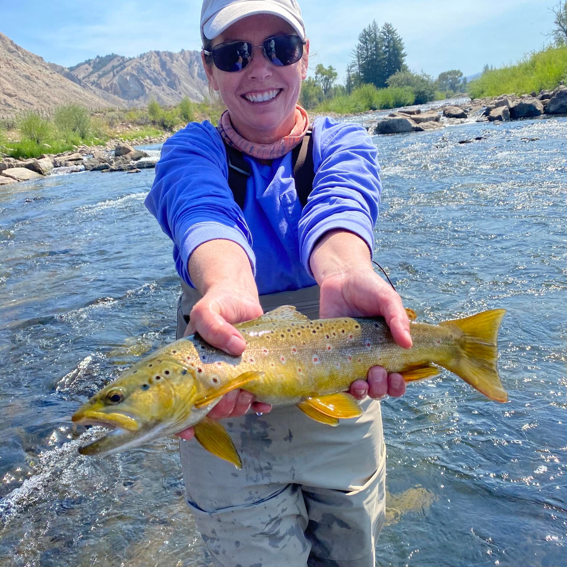 a man holding a fish in the water