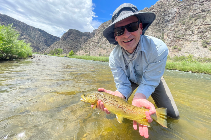 a person holding a fish in the water