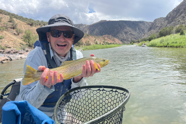 a person holding a fish in the water