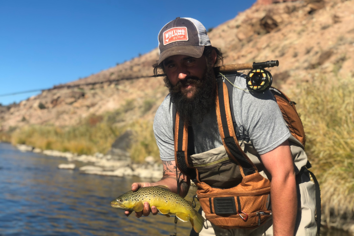 a man holding a fish in the water