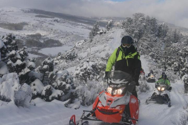 a man riding on top of a snow covered slope