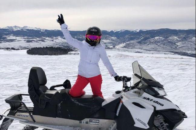 a person sitting on a snow board in the water