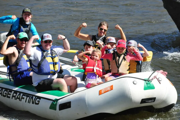 a group of people in a boat on a body of water