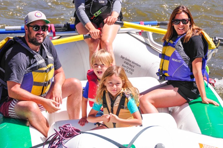 a couple of people that are sitting on a raft
