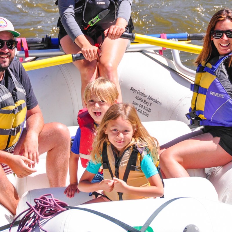 a couple of people that are sitting on a raft