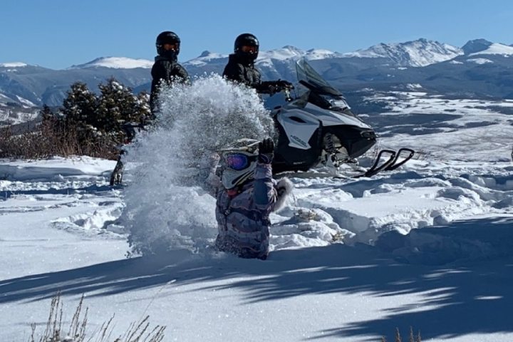 snowmobilers in the snow