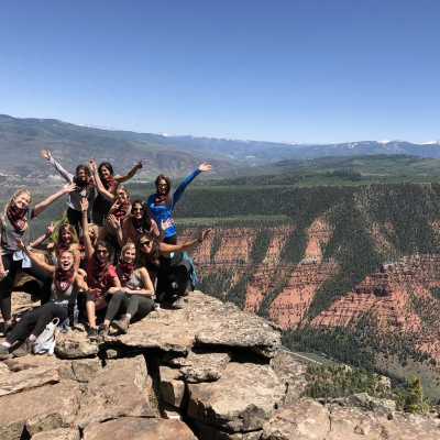 a group of people on a rocky hill