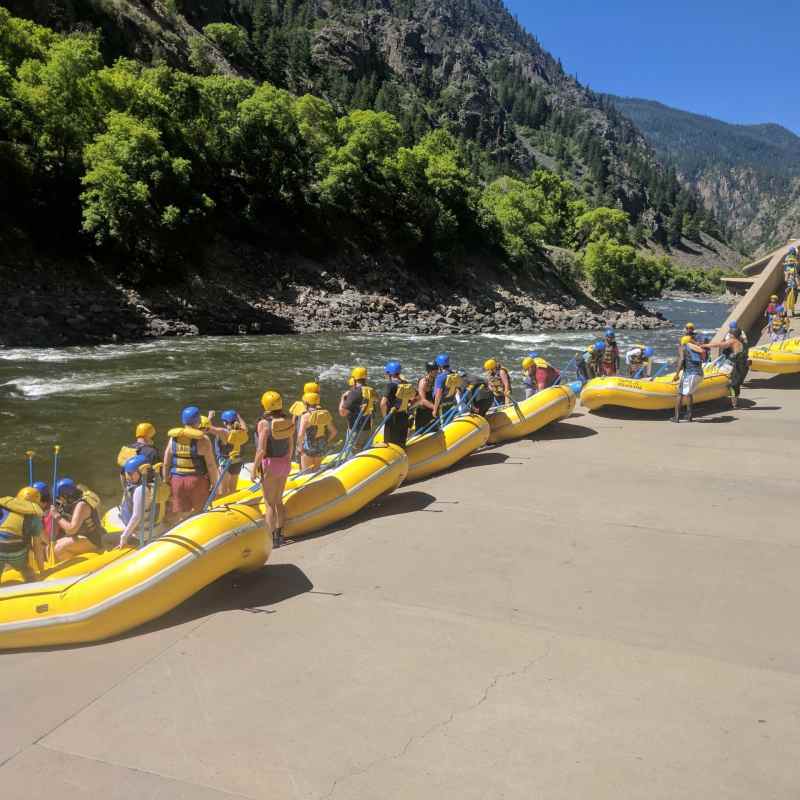 a group of people riding on the back of a boat