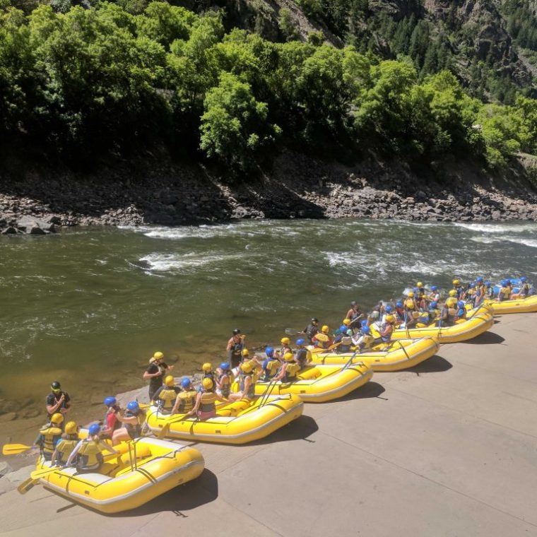 a group of people on a beach near a body of water