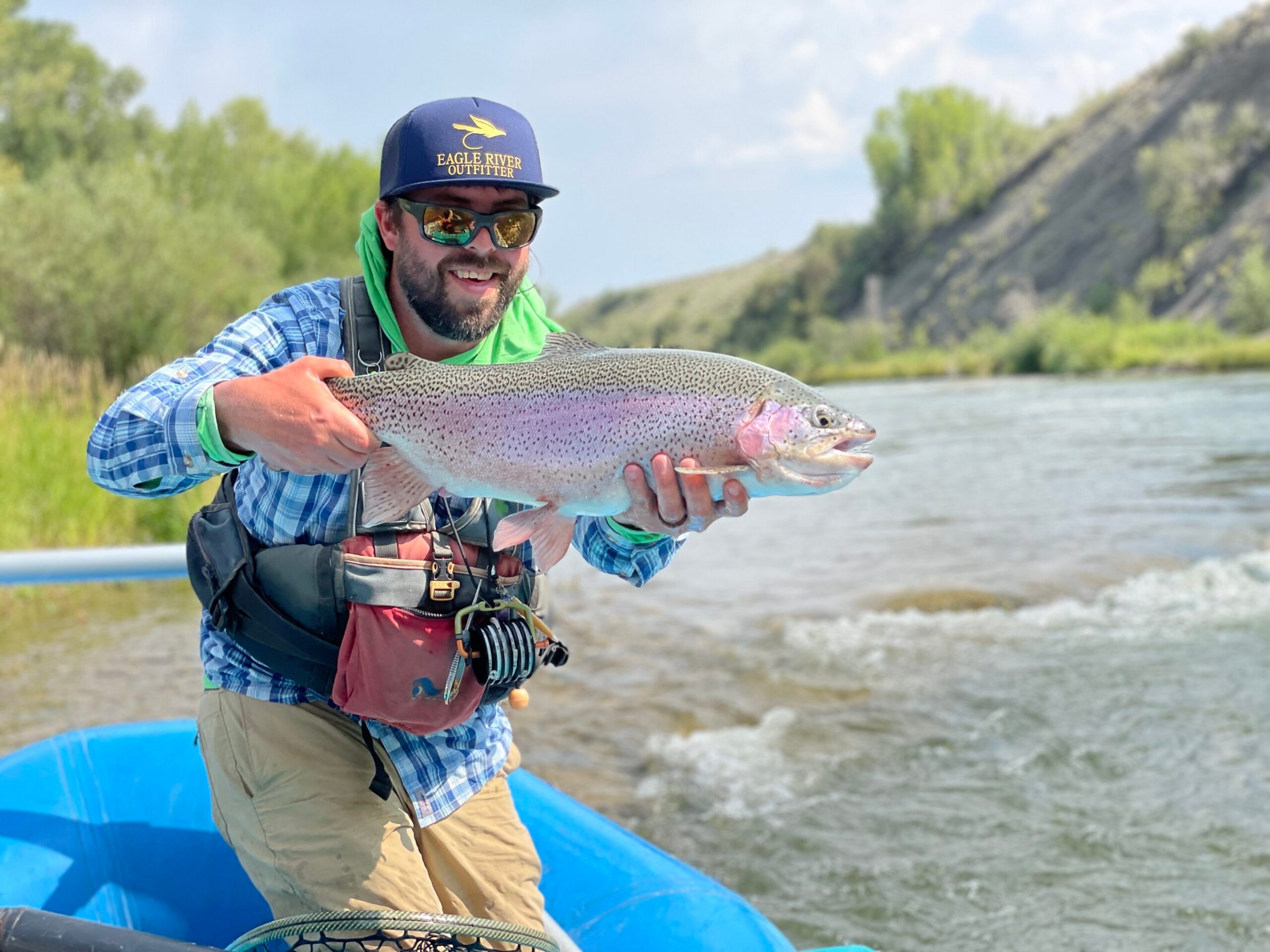 a man holding a fish in the water