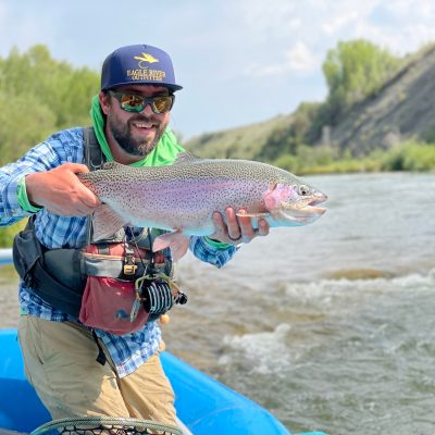 a man holding a fish in the water