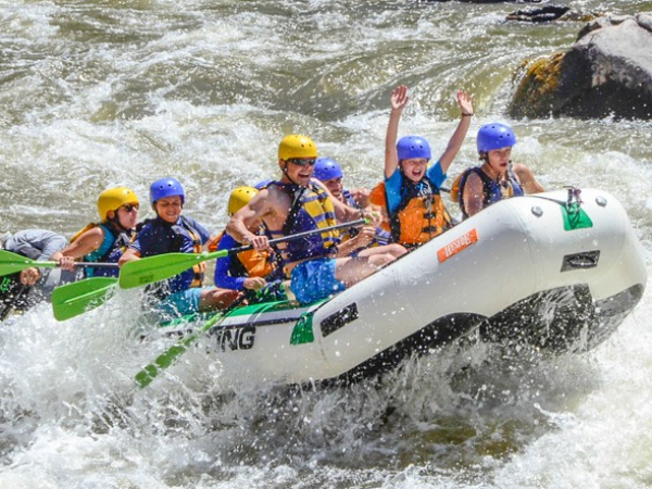 a man and a woman riding a wave on a surfboard in the water