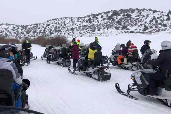 group of snowmobilers ready to go