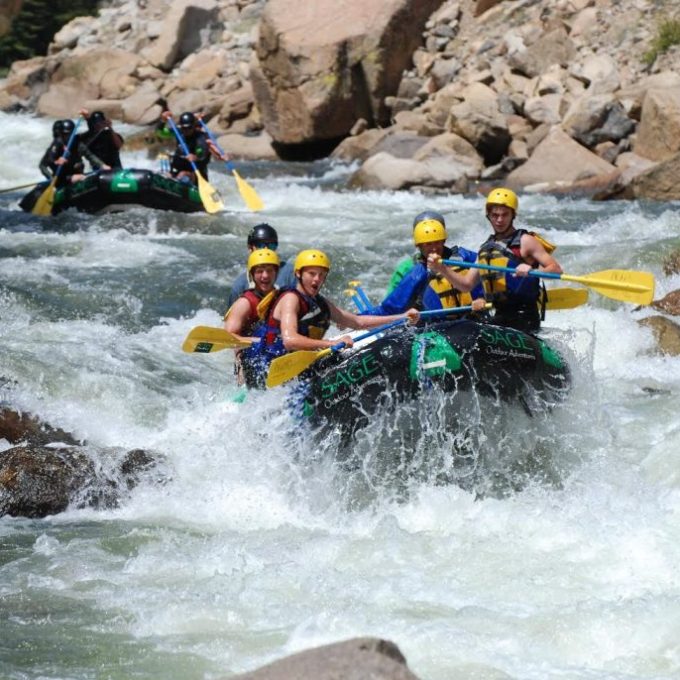 a group of people on a raft in a body of water