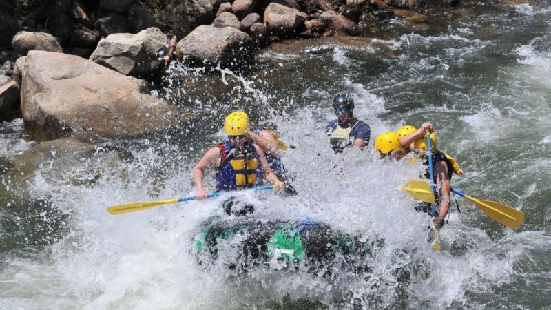 a group of people on a raft in the water