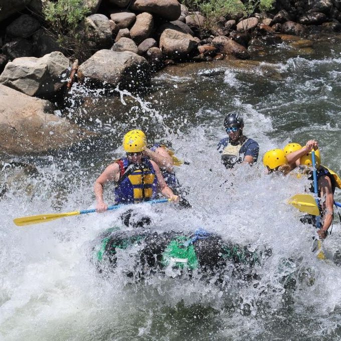 a group of people on a raft in the water