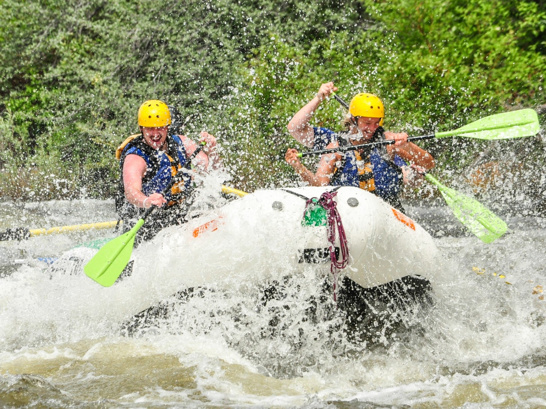 a young girl riding a wave on a surfboard in the water