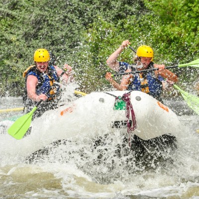 a young girl riding a wave on a surfboard in the water