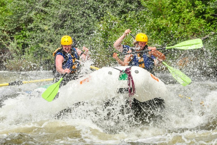 a young girl riding a wave on a surfboard in the water