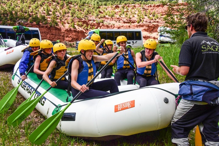 a group of people sitting on a raft in a field