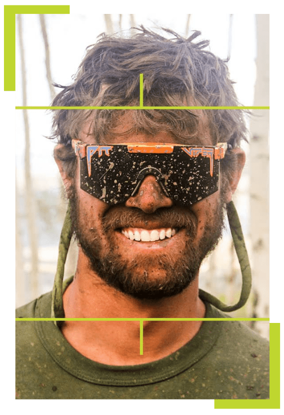 a man wearing a hat and sunglasses