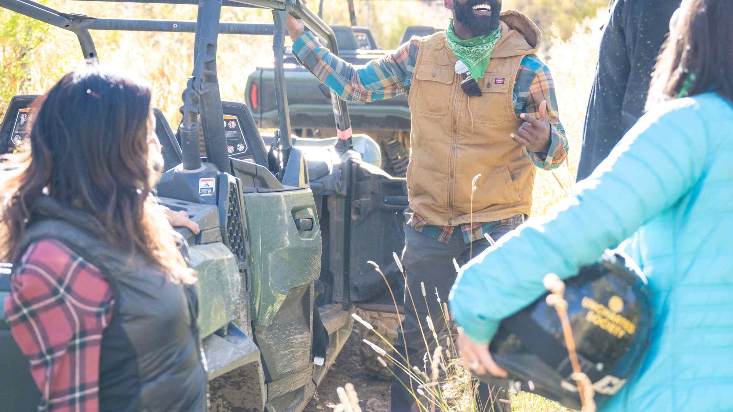 a group of people riding on the back of a truck