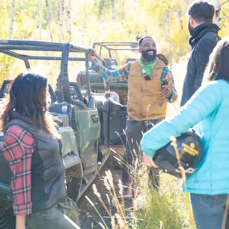a group of people riding on the back of a truck
