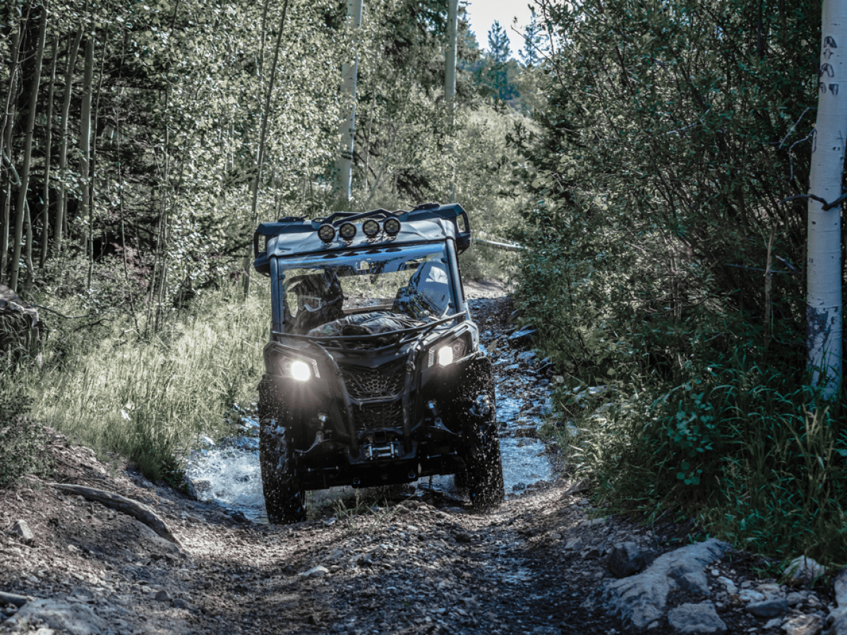 a truck driving down a dirt road
