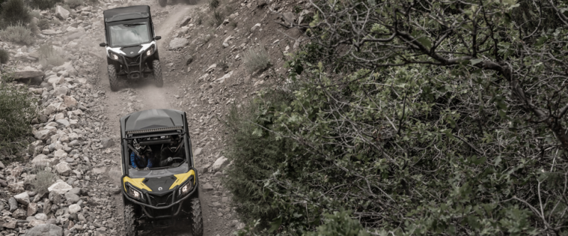 a bus traveling down a dirt road