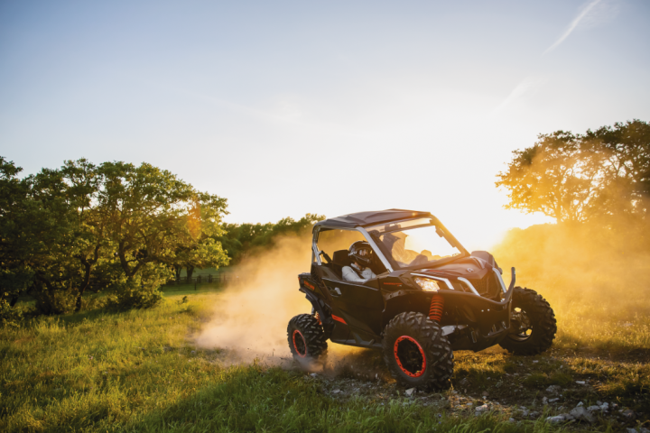 a car driving down a dirt road