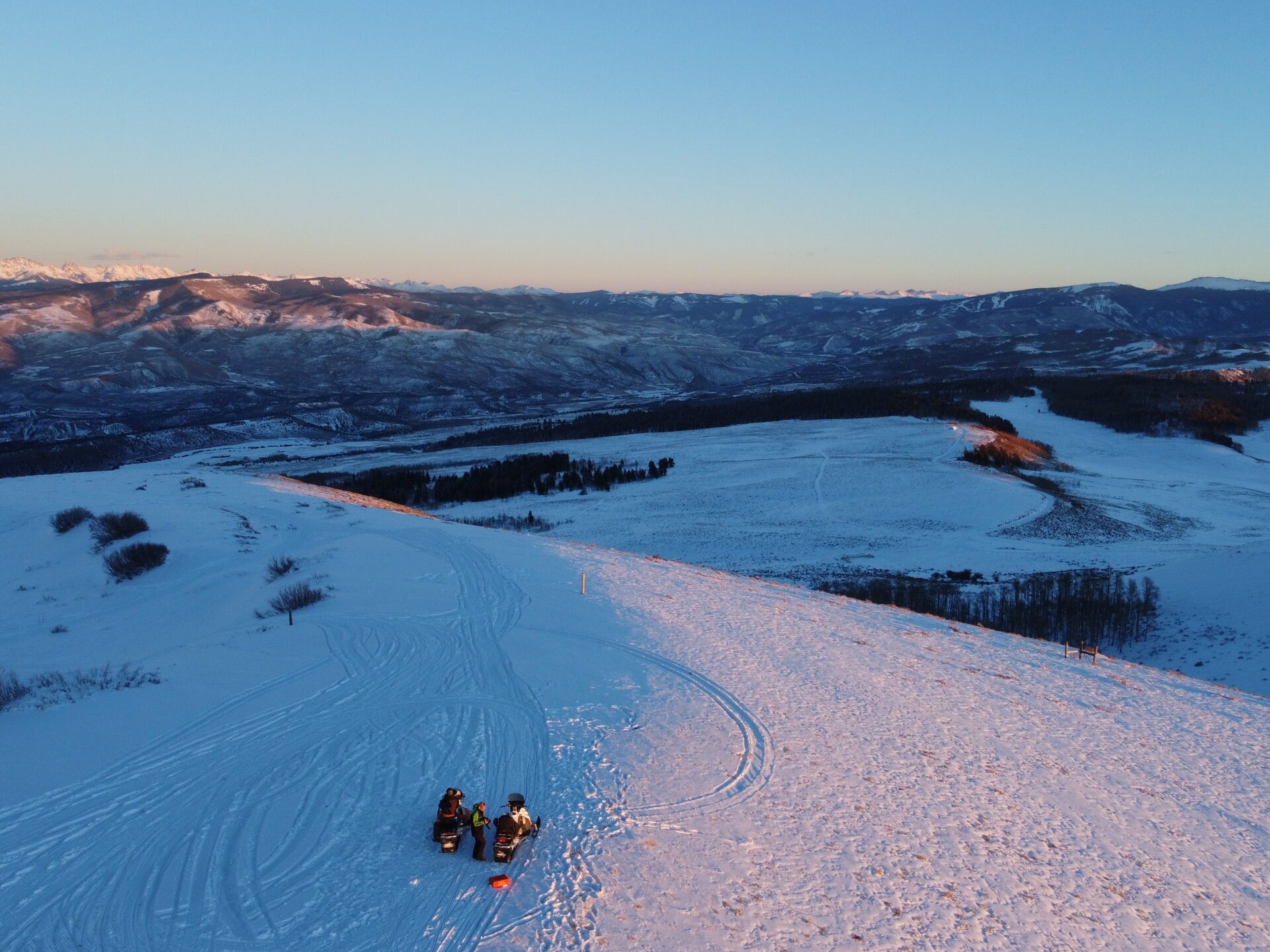 a man riding on top of a snow covered slope