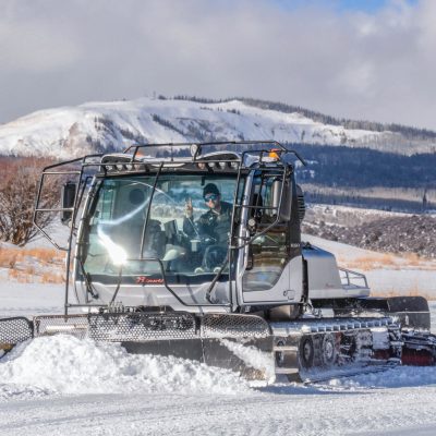 a man driving a snow covered mountain