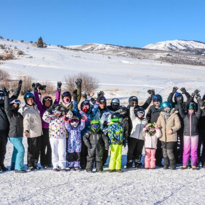 a group of people standing in the snow
