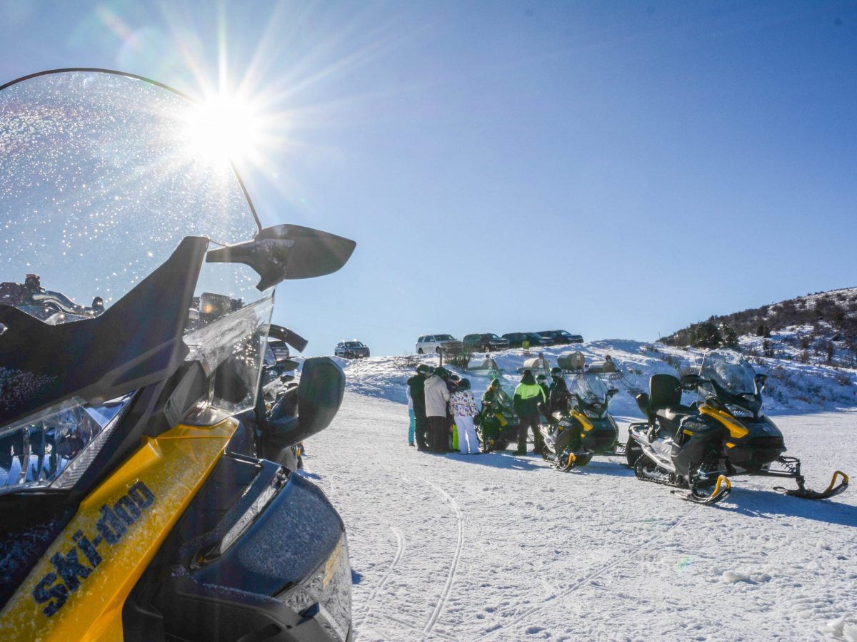 a group of people sitting in the snow