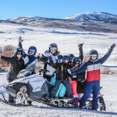 a group of people riding skis on a snowy mountain
