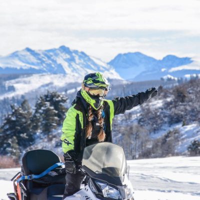 a man riding a snowboard down a snow covered mountain
