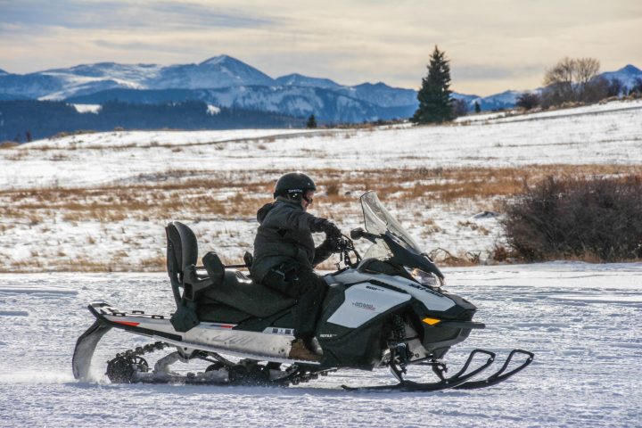 a man sitting on a snow board