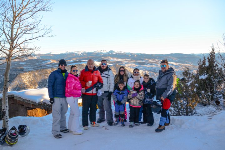 a group of people standing on top of a snow covered slope
