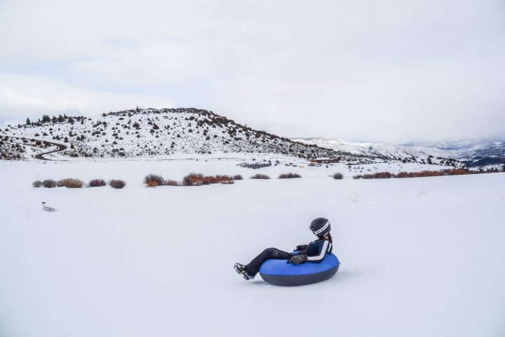 a man riding skis down a snow covered slope