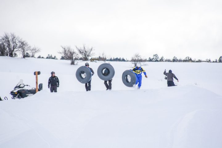 a group of people riding skis on top of a snow covered slope