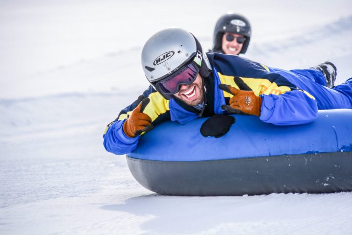 a man lying on a snow board