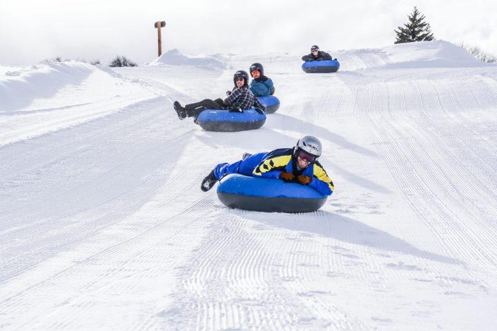 a person lying on top of a snow covered slope