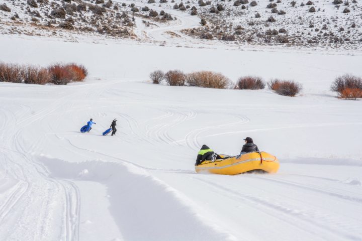 a person lying on top of a snow covered slope