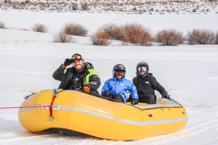 a group of people sitting in the snow