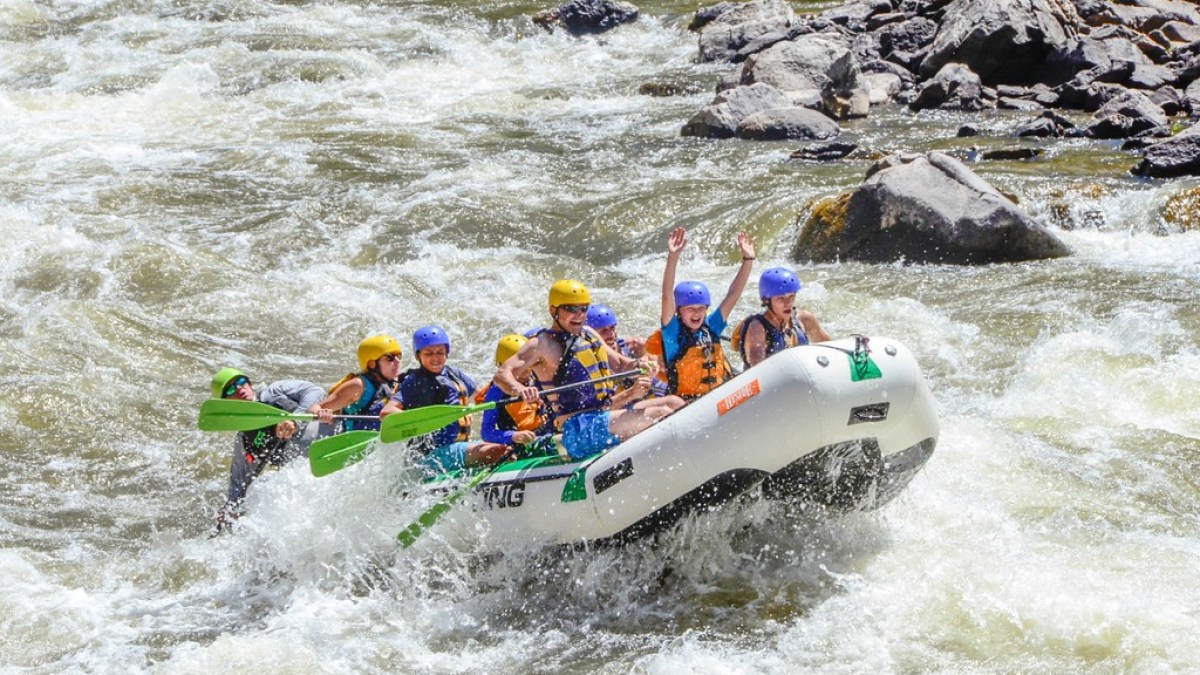 a group of people riding on a raft in the water