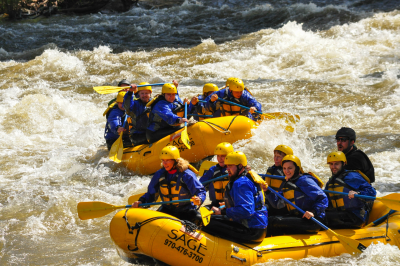 a group of people riding on a raft in the water