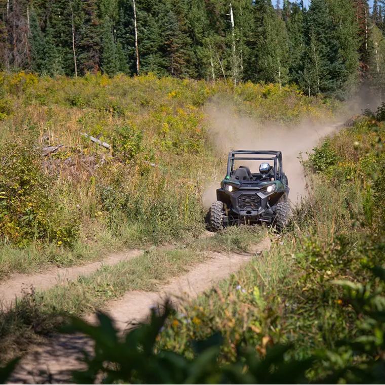 a car driving down a dirt road