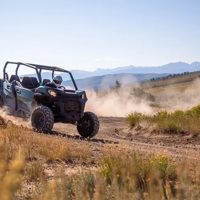 a truck driving down a dirt road