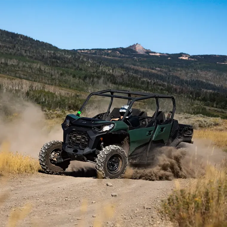 a truck driving down a dirt road