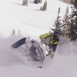 a man riding skis down a snow covered slope